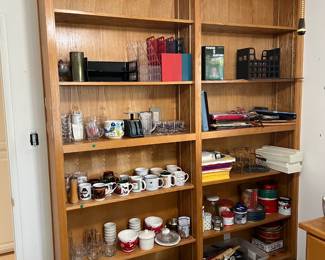 This bookcase set has more kitchen items on it, including several mugs.