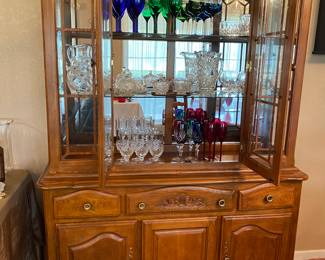 Gorgeous curio cabinet.  Champagne and wine glasses 