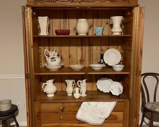 This is a LOVELY solid pine armoire - clothing bar across the top, adjustable shelving, three drawers.  Great piece!