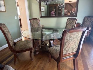 Gorgeous dining table with round glass top and matching chairs 