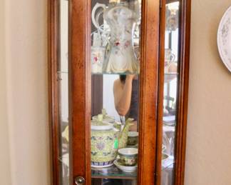 Tall wood display case with glass shelves 