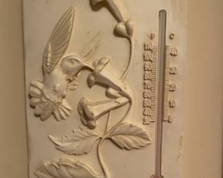 Clay wall art with thermometer.