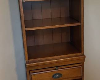 Tall corner bookcase with drawer.