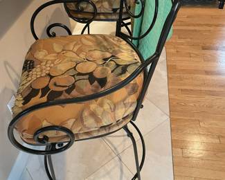 Pair of wrought iron swivel counter stool with arms (upholstered).