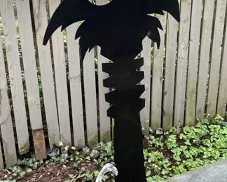 Black metal palm tree sculpture.