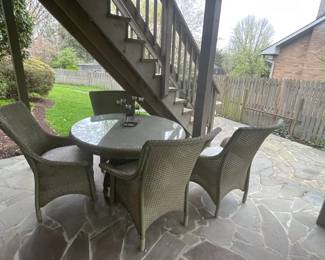 Patio set with round table and four chairs.