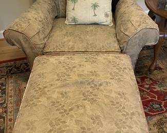 Upholstered chair with matching ottoman.