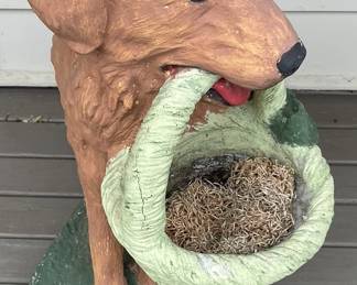Dog with basket garden sculpture.