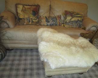 Leather sofa -hobnail detail with matching stool.  Natural fur rugs