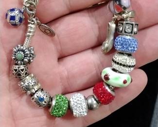 Pandora sterling charm bracelet with charms.