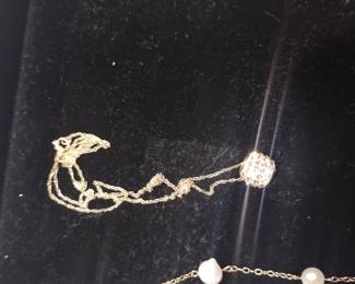 14 karat gold necklace and pendant.