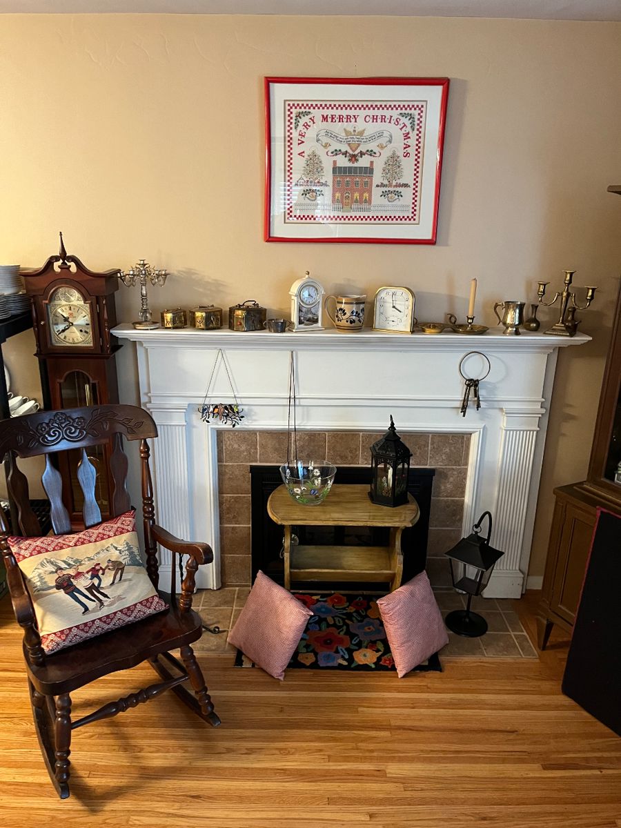 Antique rocking chair, vintage magazine rack, decorative pillows, brass clocks, nicely framed needlepoint and grandfather clock for parts only.