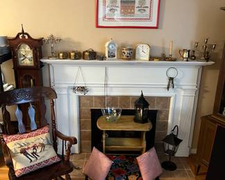 Antique rocking chair, vintage magazine rack, decorative pillows, brass clocks, nicely framed needlepoint and grandfather clock for parts only.