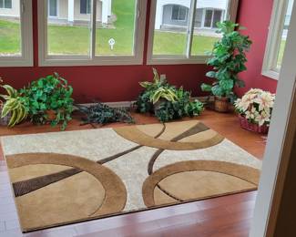 Sun room with a collection of artificial flower arrangements.
Also a made in Turkey 5'3"x7'6" Rug