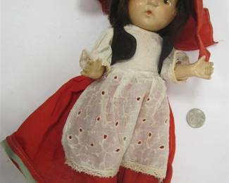  ANTIQUE 13" COMPOSITION DOLL.  PAINTED EYES AND MOUTH.  MISSING ONE SHOE.  UNDER CLOTHES STILL STAPLED TO BODY.  MISSING ONE SHOE.  WEAR FROM AGE AND PLAY.