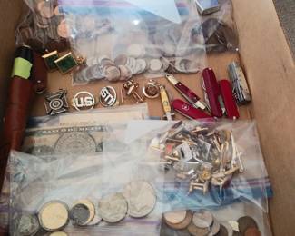 Old coins, knives, cufflinks and other small collectibles.