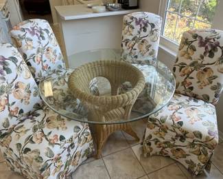 Now $150 !!!! (4/7) was $395.00 Wicker glass table with 4 botanical upholstery chairs on casters 44 round 29 H