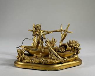 LAD FISHING DESK ORNAMENT | Depicts a small shirtless boy net fishing from a boat among the reeds