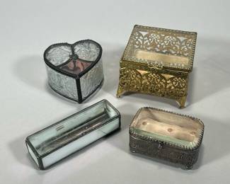 (4PC) METAL & GLASS JEWLERY CASES | Includes: silver jewelry box with stamped flowers and glass top, square gilt jewelry box with glass top, rectangular mirrored glass jewelry case, and heart shaped glass jewelry box