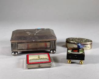 DECORATIVE METAL BOXES | Includes; decorative stamped box with initial “E” on top, commemorative Statue of Liberty compact, small box with bird, and larger decorative metal box with animal figure and turquoise on top