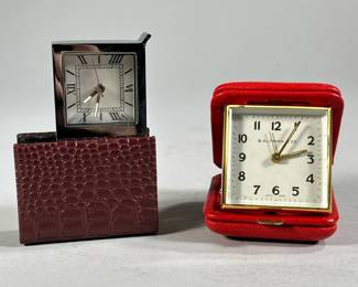 (2PC) LEATHER BOUND TRAVEL CLOCKS | Includes: B. Altman travel clock in red leather case, and other leather bound travel clock