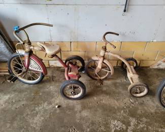 Two vintage tricycles.