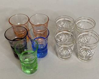 Five Colored Glass Shot Glasses With Four Gold And White Shot Glasses
