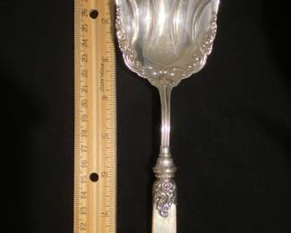 Sterling with mother of pearl handle.