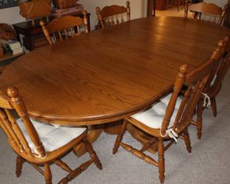 Oak dining room table with 6 chairs and extra leaves (not all shown)
