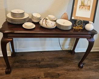 slim console with vintage dishes