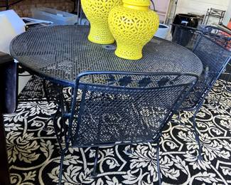Wrought iron table and 4 chairs..indoor/outdoor rug. 
