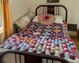 Pretty metal bed frames, linens and lots of prints and posters