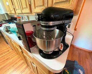Kitchen Aid mixer with parts still in the box.