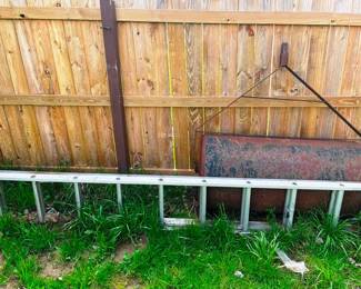 A big lawn roller and ladder