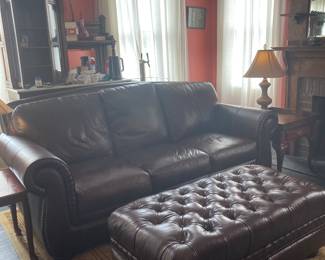 ONE YEAR NEW HAVERTY LEATHER SOFA AND TUFTED OTTOMAN