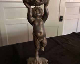 METAL STATUE OF CHERUB? HOLDING A VASE/BOWL. LOOKS LIKE A PLACE TO PUT CIGARETTE BUTTS/ASHES. 
