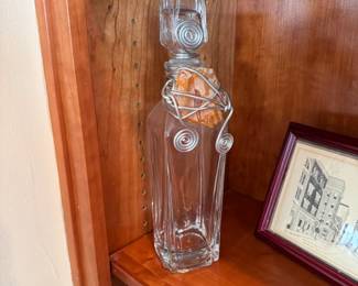Glass decanter with wired decorative cover (stone encased has a crack) 11"H
