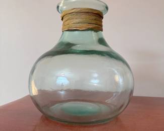 Glass vase with green hue and grass neckband 9"H
