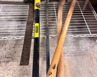 Grouping of large hand tools - square, pry bar, sledge hammers 