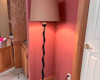 Floor lamp with ringed metal body and tan shade 60"H (in upper level)