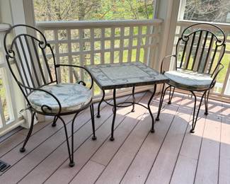 Cast iron chairs with mesh seat (likely Meadowcraft) matching table with mosaic tiled top (some wear and a few missing tiles) table is 22"H x 24"W (Set R)
