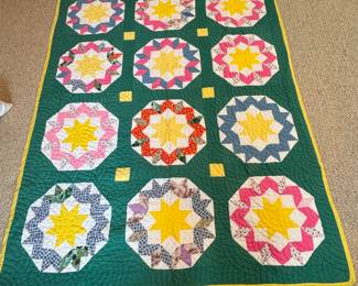 Hand-made star block quilt with green background and yellow border, white backing, has very minor spots or flaws, roomy twin size at 62" x  84"