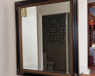 Beveled mirror in black wooden frame with bronzed accents 30" x 24"
