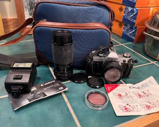 Canon AE-1 35mm camera with flash and 50mm & 80-200mm lenses, lenses appear clear, camera advances smoothly, comes with bag 