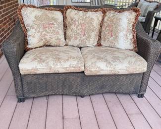 Patio loveseat with floral cushions, some wear, 58"W x 32"D