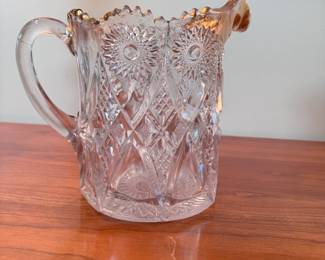 EAPG pitcher with crosshatching, hobstars, and gold-coated sawtooth lip, there may be hairlines in the handle, and there is a stable round crack on the back near the bottom, beautiful for a display piece or vase 7"H