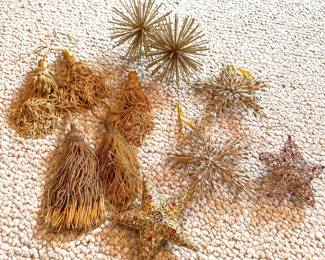 Grouping of gold decorations, fringed and beaded tassels, metal stars