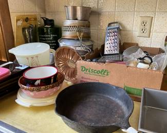 Kitchen - covered Tupperware plate carrier with lid, a covered Tupperware mixing bowl with lid, bowls, metal small pan, strainer & strainer basket 