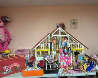 1980s Barbie dream house with Barbie’s and various dolls. 
