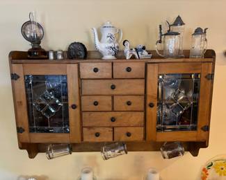 Antique wall hanging cabinet with gorgeous stained glass panel doors and storage drawers
